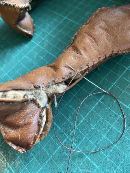 An old leather camel dating from WW2 that is being re-stitched